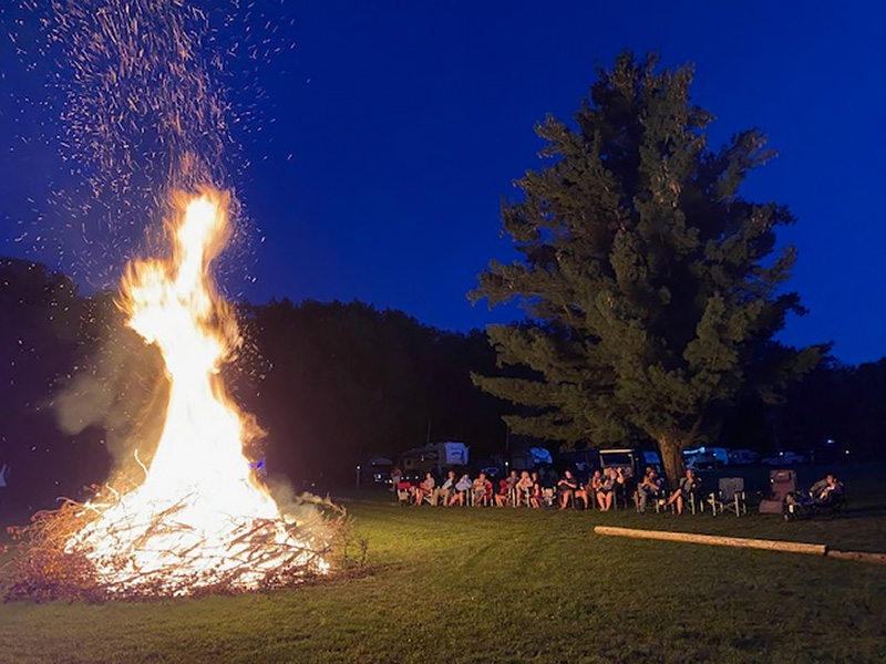 Bonfire in field at Hide-A-Way Campsites